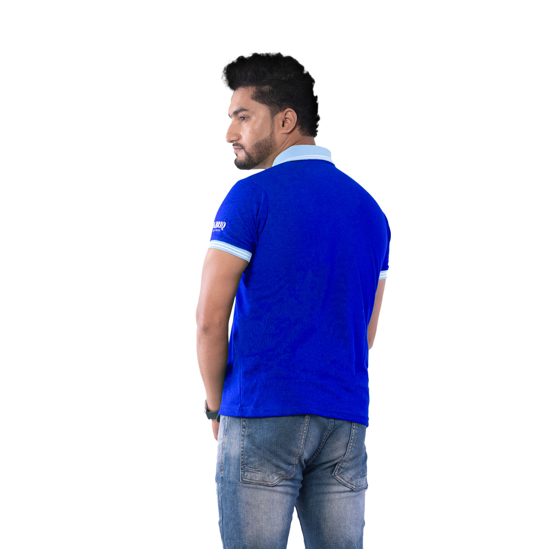 Man wearing a blue polo shirt with a visible brand logo on the back, standing against a white background.