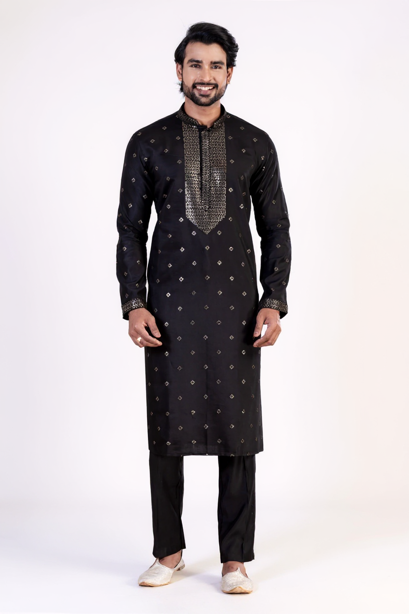 Man wearing a black kurta with white patterns on a white background