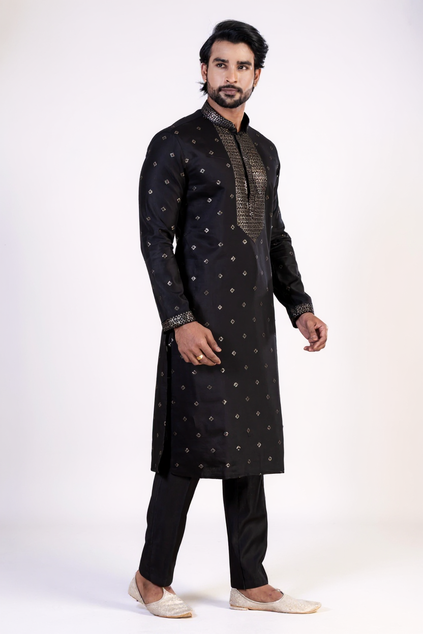 Man wearing a black kurta with white patterns on a white background