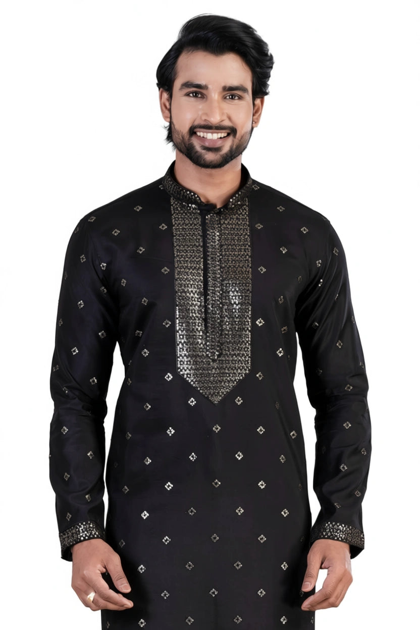 Man wearing a black embroidered kurta with silver details on a white background