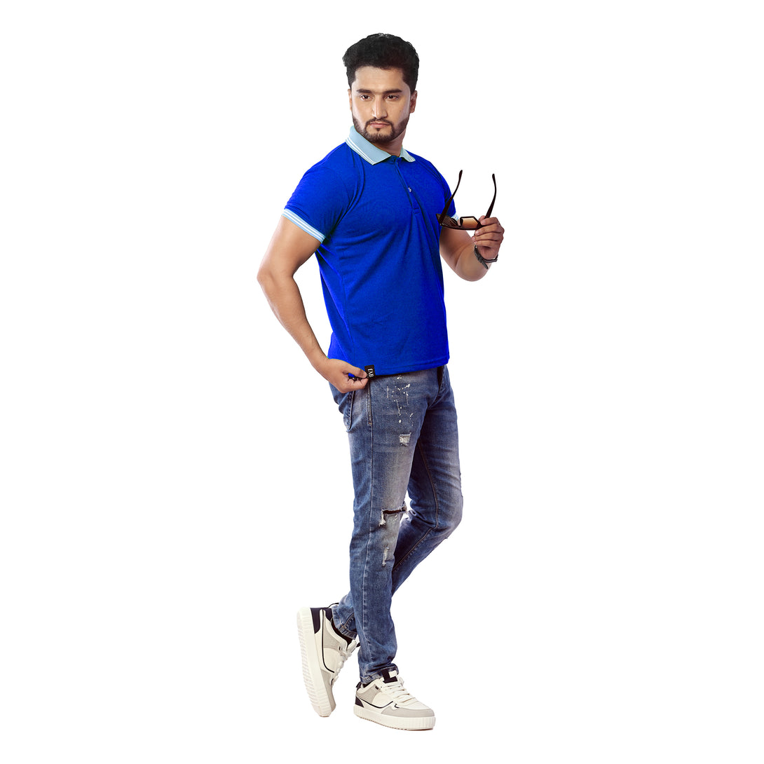 Man wearing a blue polo shirt and jeans holding sunglasses on a white background